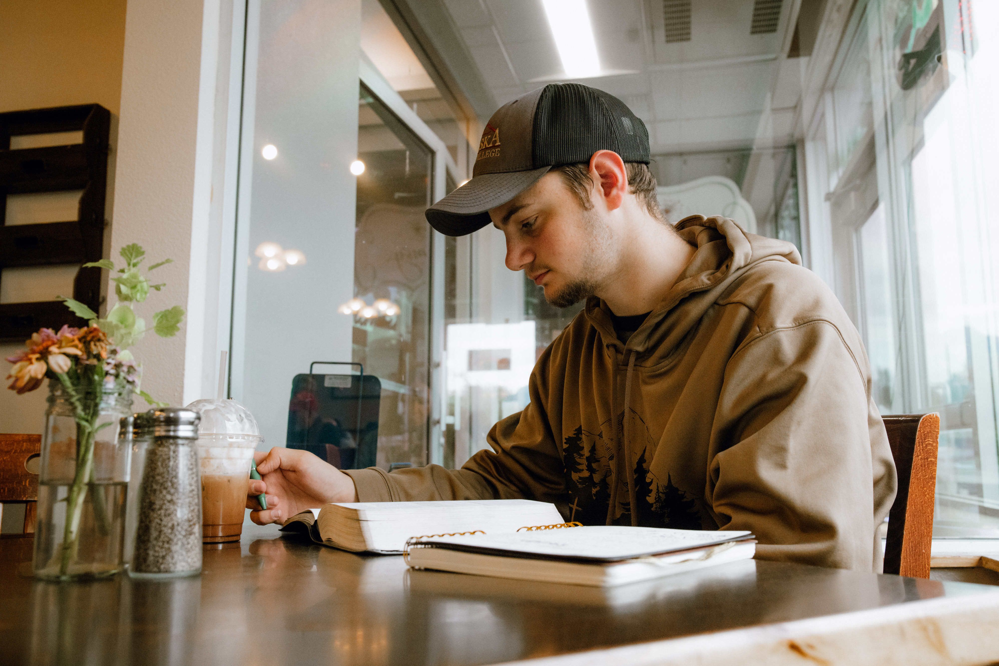 An Alaska Bible College student studying Scripture in class