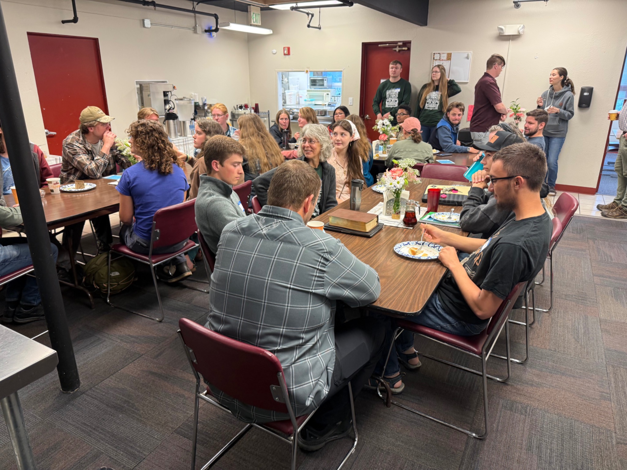 Alaska Bible College students gathered around tables for a community meal