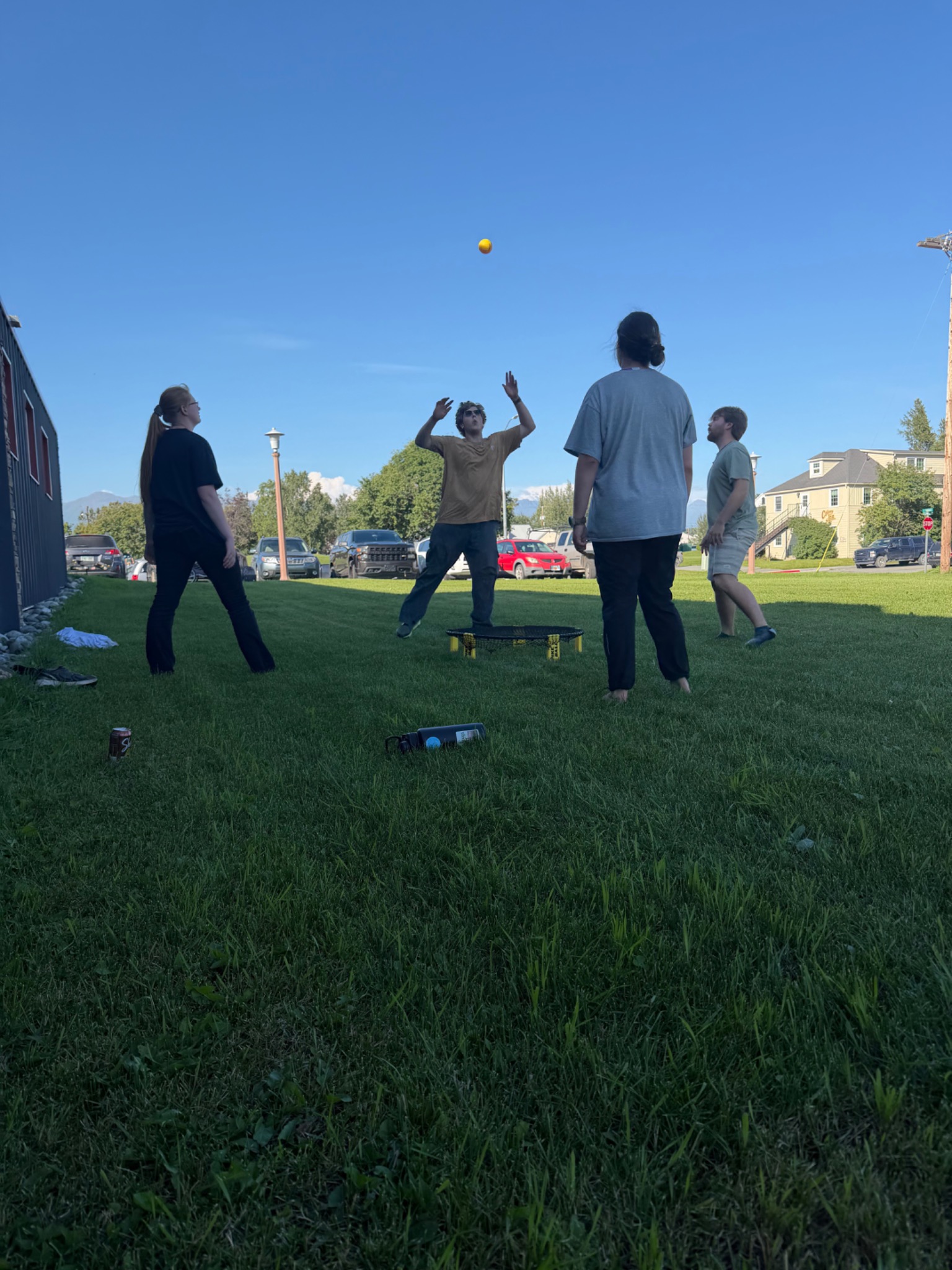 Students playing a lawn game outside the ABC Quadplex